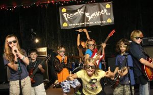 Children on instruments in the DeAngelis Rock School.