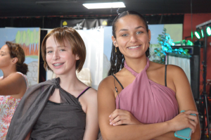 Two DeAngelis stundents in stage costume smiling at camera.